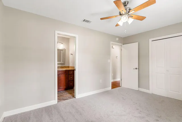 a view of an empty room with a fan