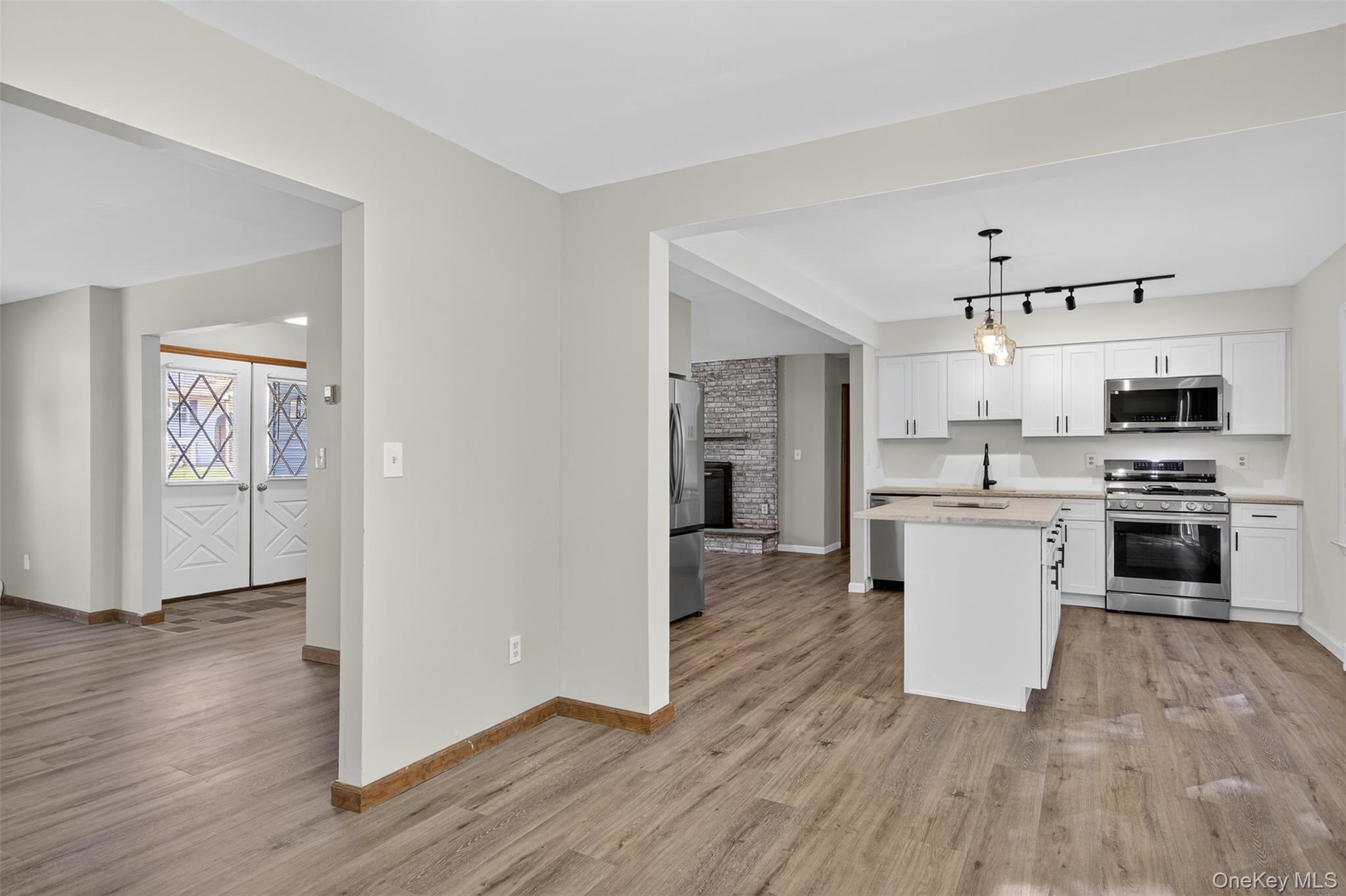 13 Farmstead Road New Windsor, NY 12553 - Photo 11 of 27 a kitchen with wooden floors and white appliances