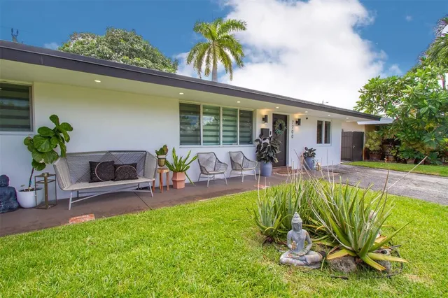a view of a house with swimming pool and sitting area