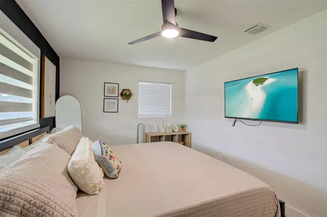 a bedroom with a large bed and a table