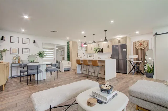 a living room with furniture a dining table and kitchen view