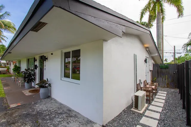 an aerial view of residential houses with outdoor space and trees