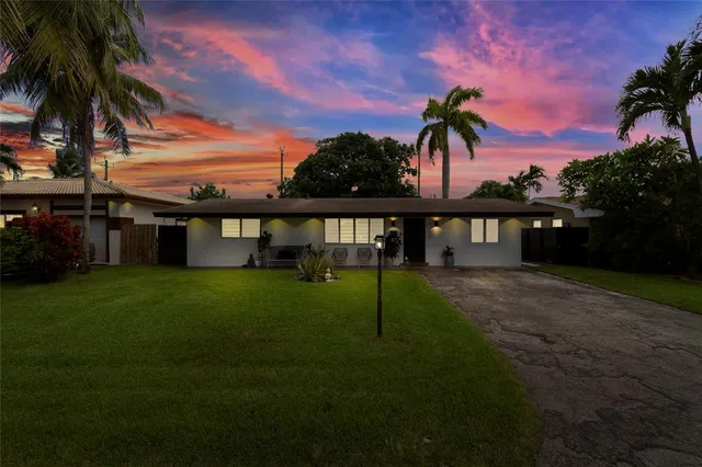 an aerial view of residential houses with outdoor space and street view