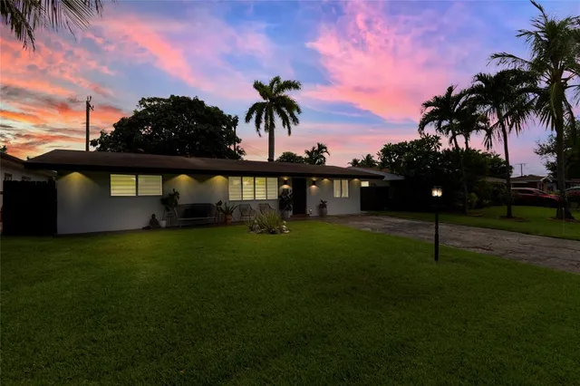 an aerial view of residential houses with outdoor space and street view