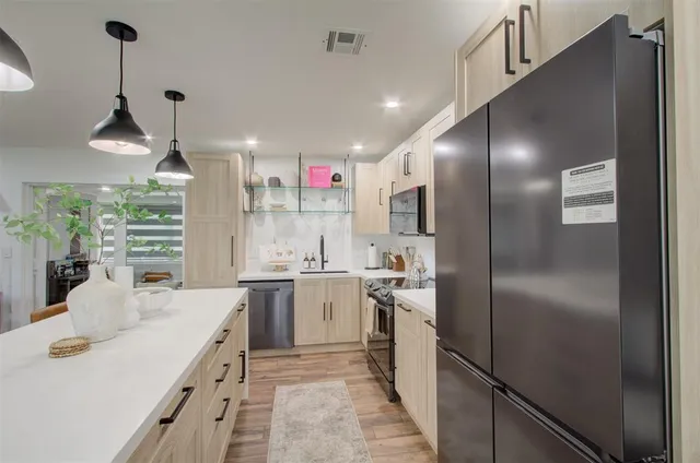 a kitchen with white cabinets and stainless steel appliances