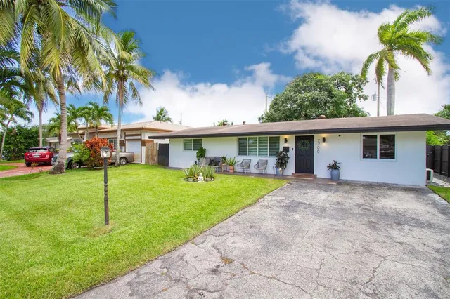 a front view of house with yard and green space