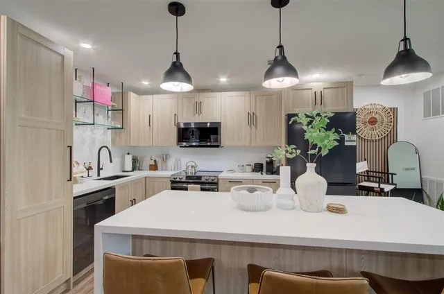 a kitchen with a sink a stove and cabinets