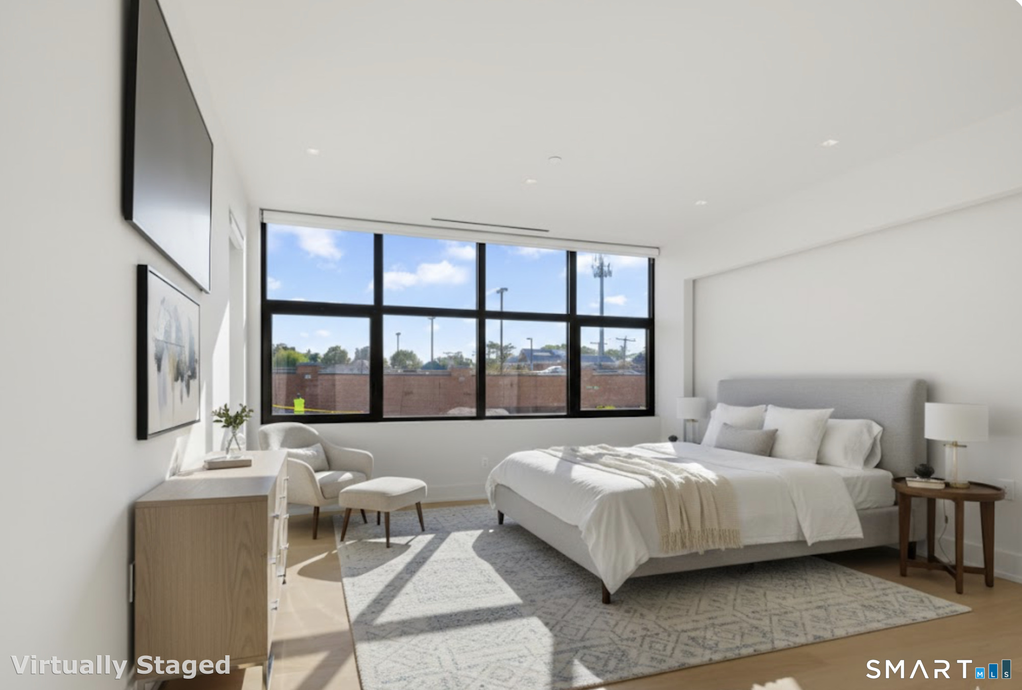 116 Sherman Street, Unit 2 Fairfield, CT 06824 - Photo 11 of 31 a bedroom with a bed and a large window