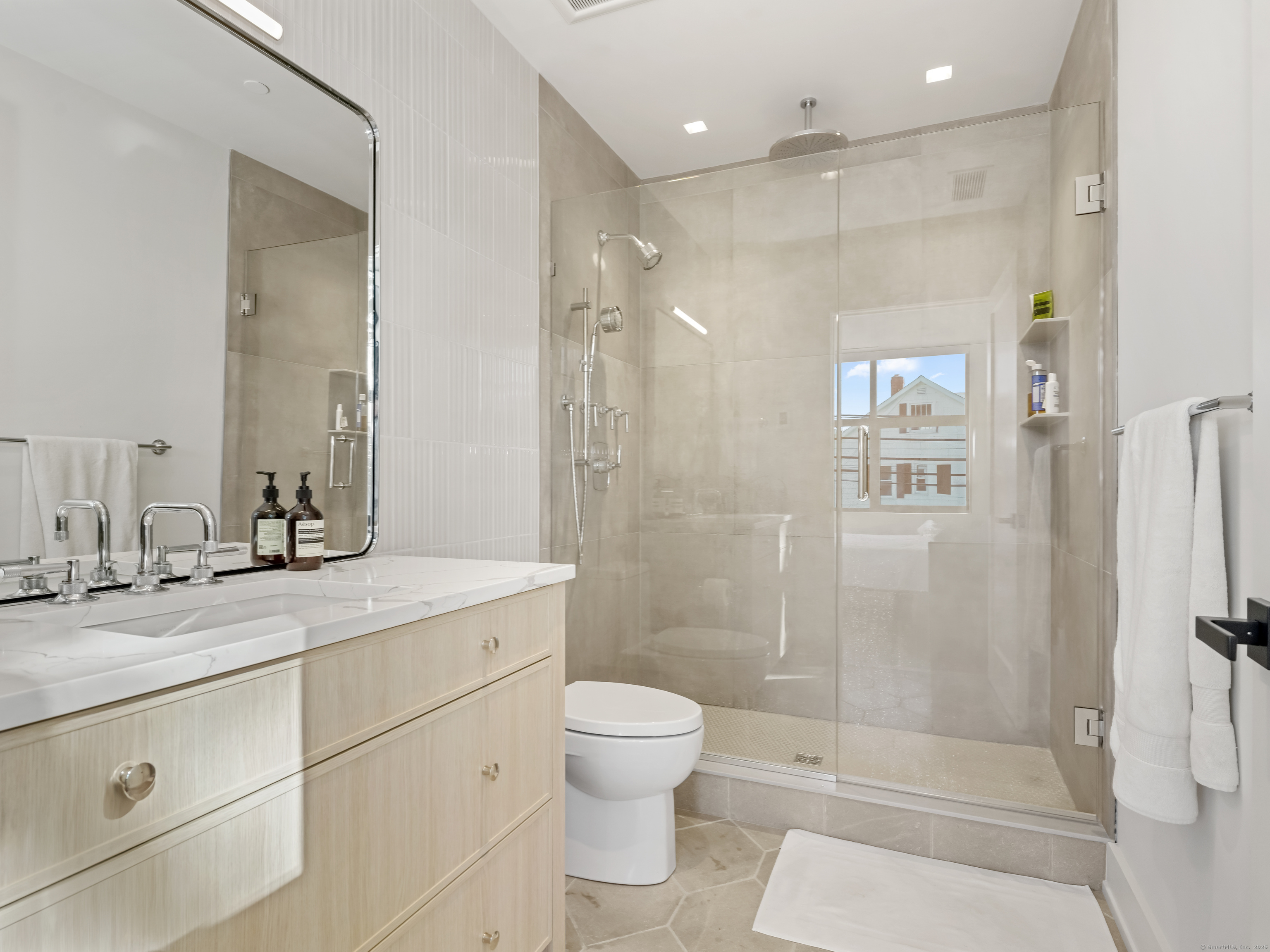 116 Sherman Street, Unit 2 Fairfield, CT 06824 - Photo 14 of 31 a bathroom with a shower sink vanity mirror and toilet