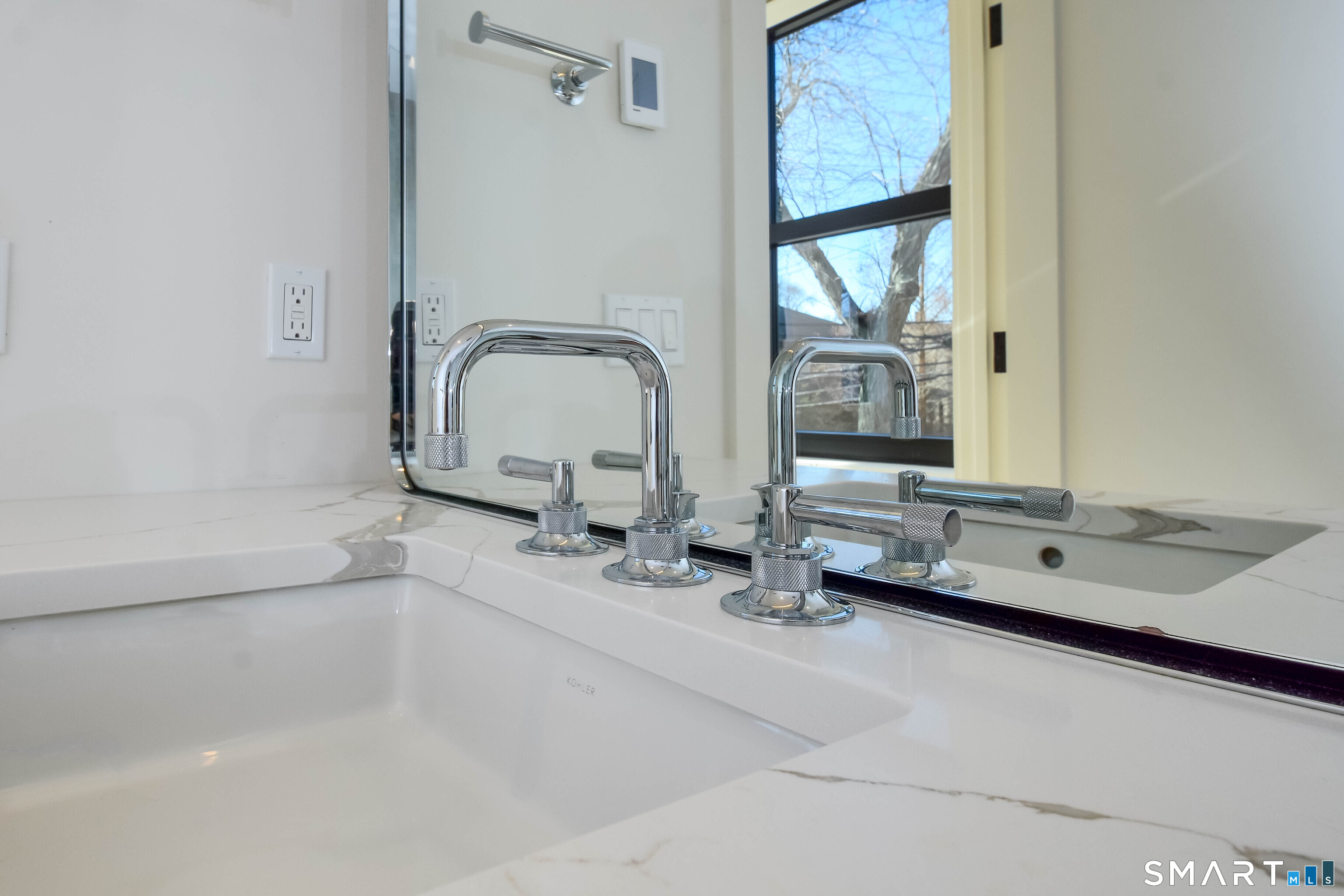 116 Sherman Street, Unit 2 Fairfield, CT 06824 - Photo 28 of 31 a bathroom with a double vanity sink and a mirror