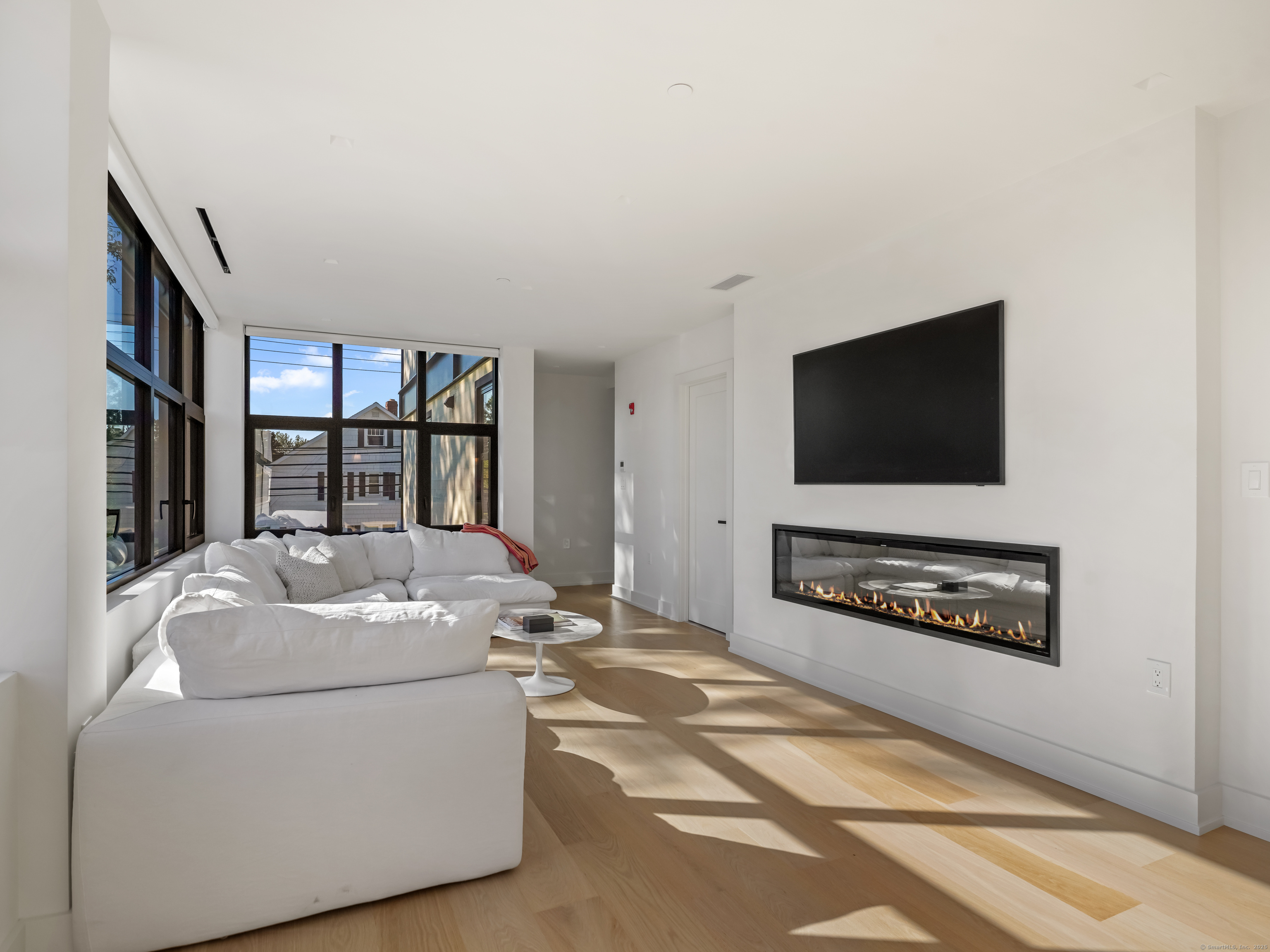 116 Sherman Street, Unit 2 Fairfield, CT 06824 - Photo 10 of 31 a living room with furniture and a flat screen tv