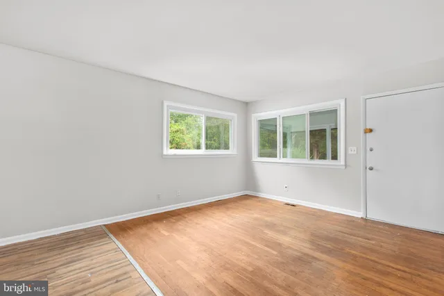 a kitchen with a sink cabinets stainless steel appliances and a window