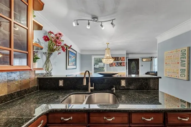 a kitchen with stainless steel appliances a refrigerator a stove a sink and dishwasher