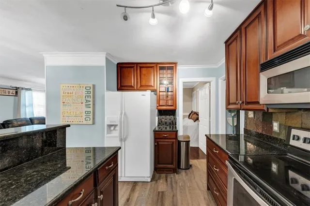 a kitchen with granite countertop a sink and cabinets