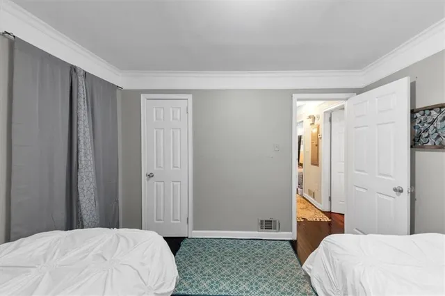 a bedroom with a large bed and a chandelier