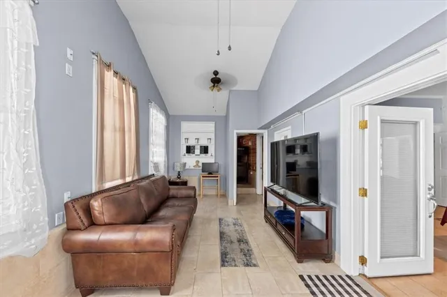 a spacious bedroom with a bed a couch and potted plant
