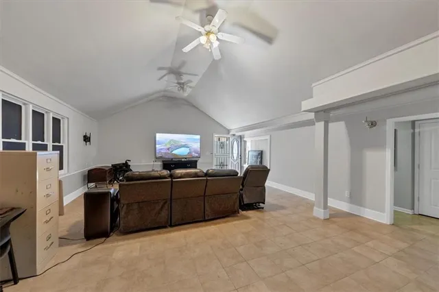 a front view of a house with a yard and potted plants