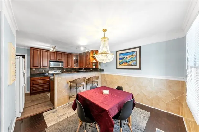 a kitchen with stainless steel appliances granite countertop a stove a sink dishwasher and cabinets with wooden floor