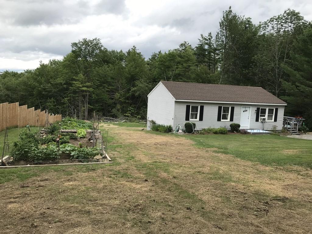 8 Dolbier Hill Road Templeton, MA 01468 - Photo 2 of 15 a front view of a house with a garden