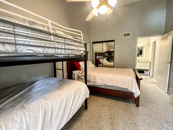 a bedroom with a bed and a chandelier