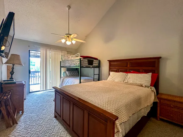 a bedroom with a large bed and a chandelier