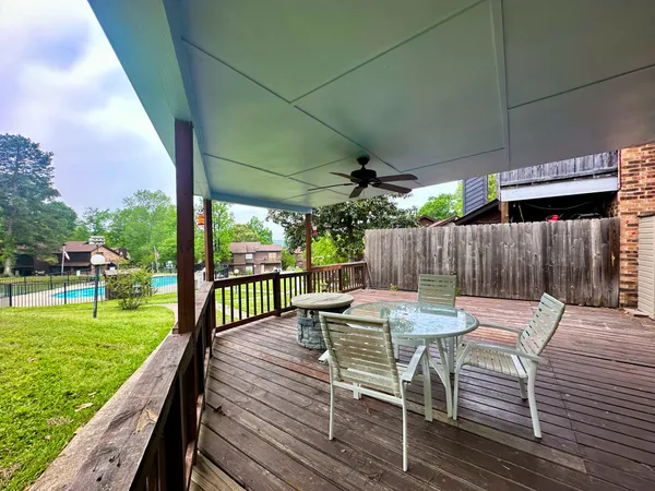 a view of a patio with a table chairs and a backyard