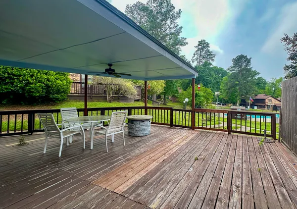 a view of a chairs and table on the wooden deck