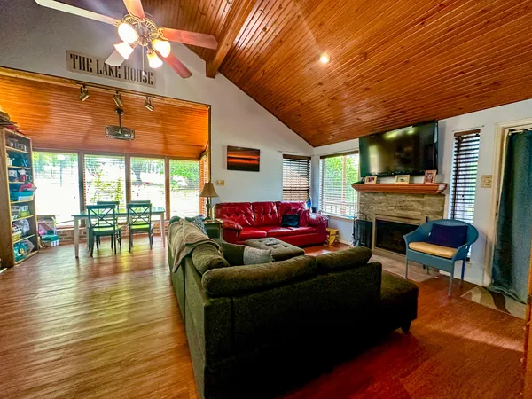 a living room with furniture wooden floor and a fireplace