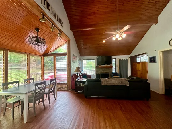 a living room with furniture a fireplace and wooden floor