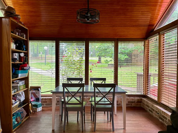 a dining room with furniture and a window