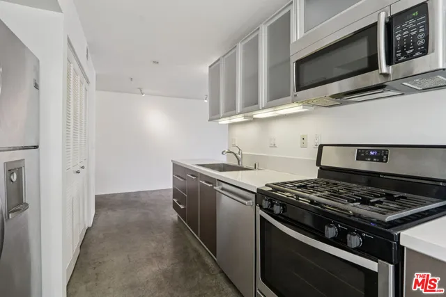 a kitchen with stainless steel appliances and white cabinets