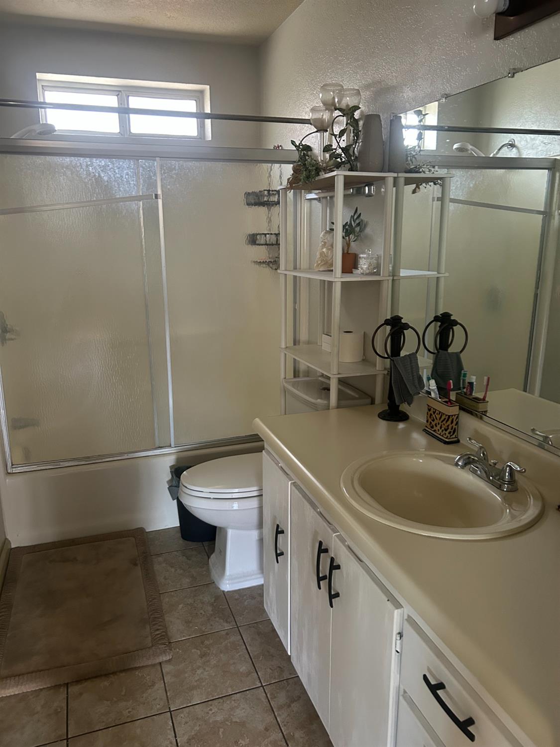 304 North Madison Street Modesto, CA 95351 - Photo 7 of 12 a bathroom with a sink a toilet and shower