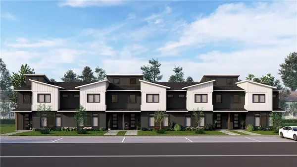 a view of a big house in a big yard with large trees