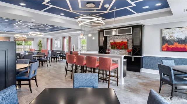 a view of a dining room with furniture wooden floor and chandelier