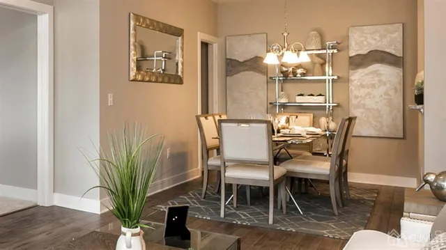 a dining room with furniture and a potted plant