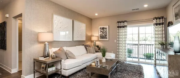 a living room with furniture and a lamp