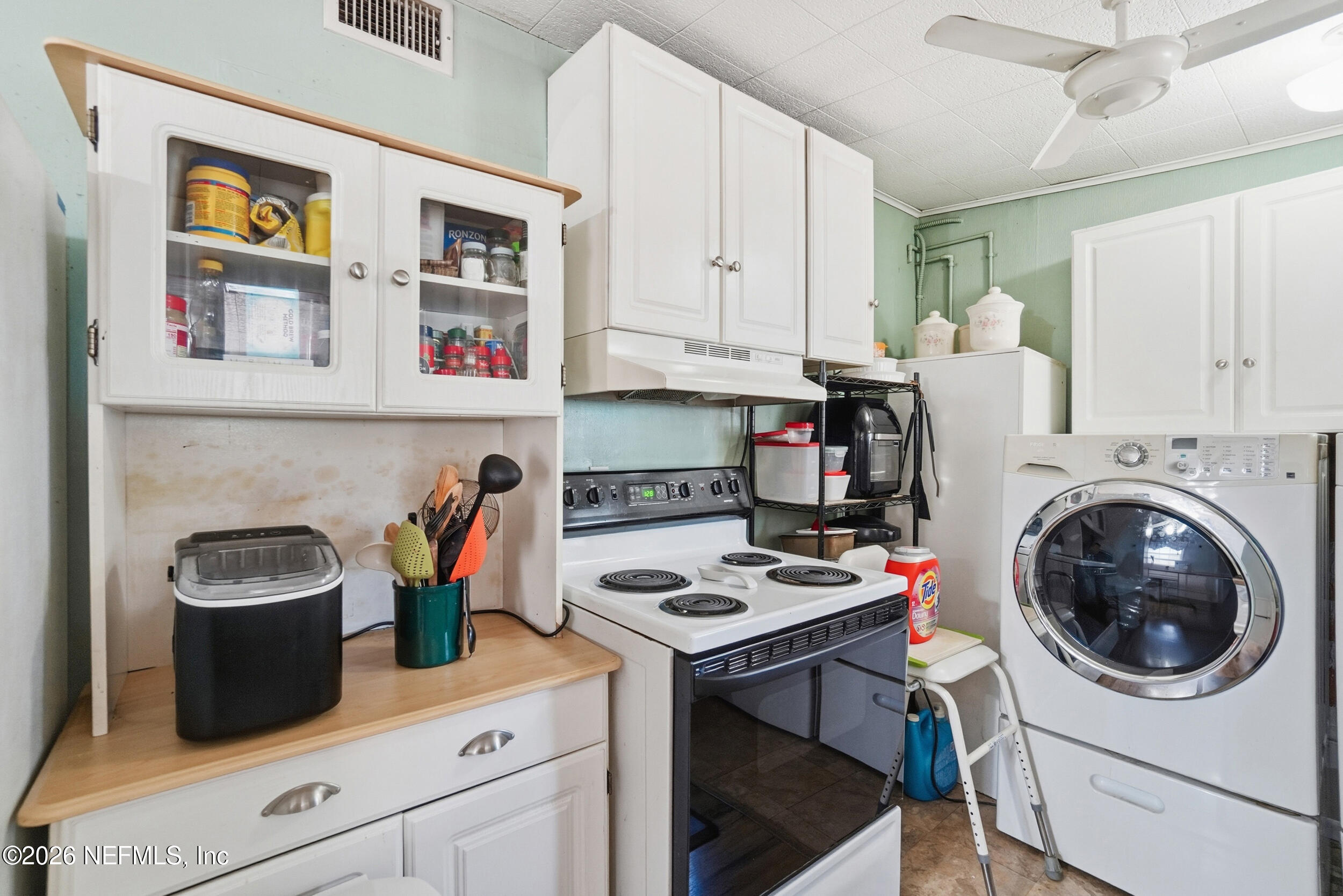 43 Forrestal Circle North Atlantic Beach, FL 32233 - Photo 11 of 39 a kitchen with a stove a sink and a refrigerator