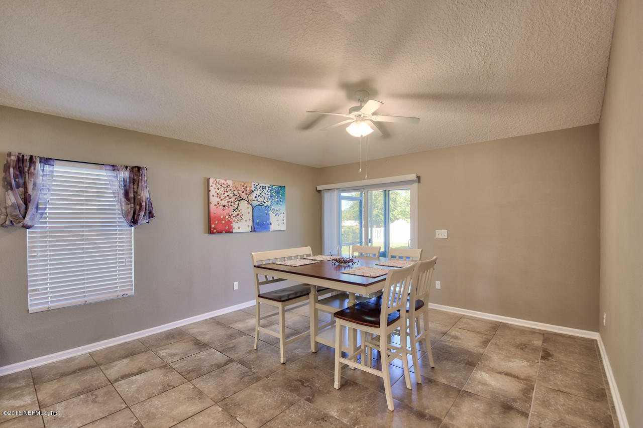 26 North Twin Maple Road St. Augustine, FL 32084 - Photo 11 of 26 a view of a dining room with furniture and chandelier