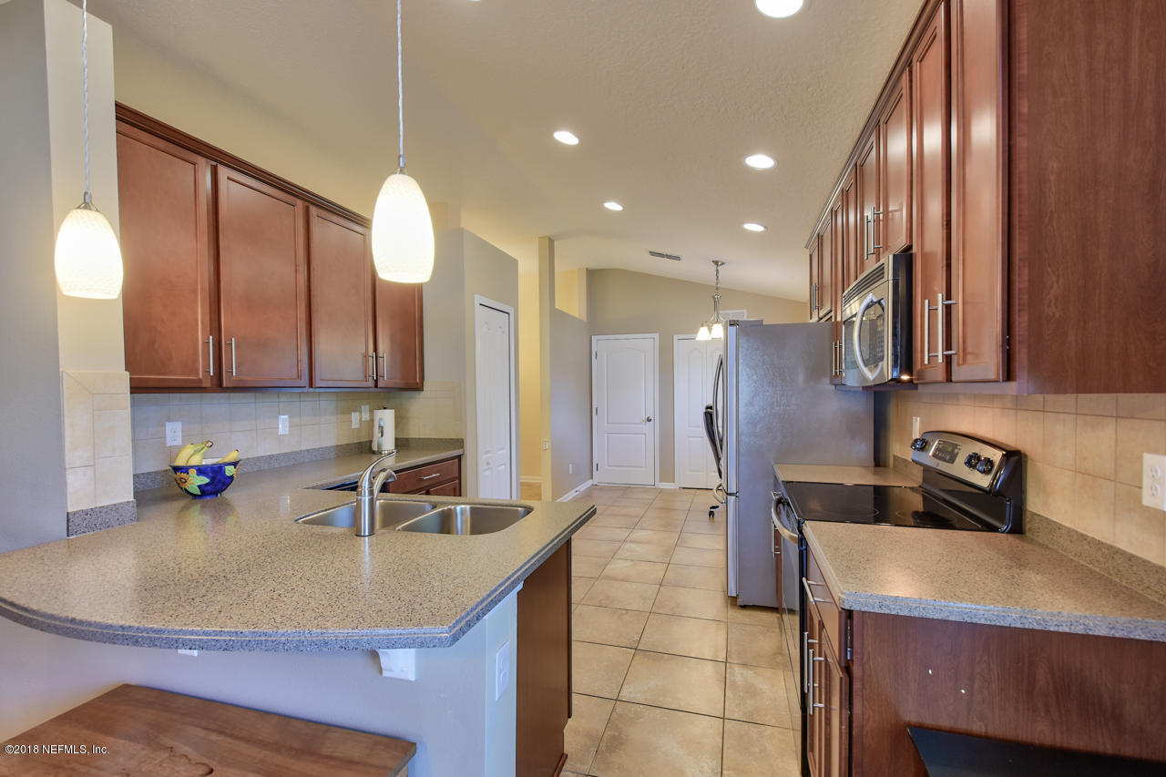 26 North Twin Maple Road St. Augustine, FL 32084 - Photo 6 of 26 a kitchen with kitchen island a sink appliances and cabinets