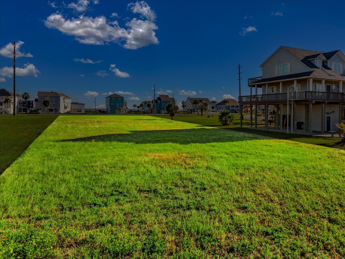18703 Shaman Road Galveston, TX 77554 - Photo 12 of 20 a view of a big house with a big yard and potted plants