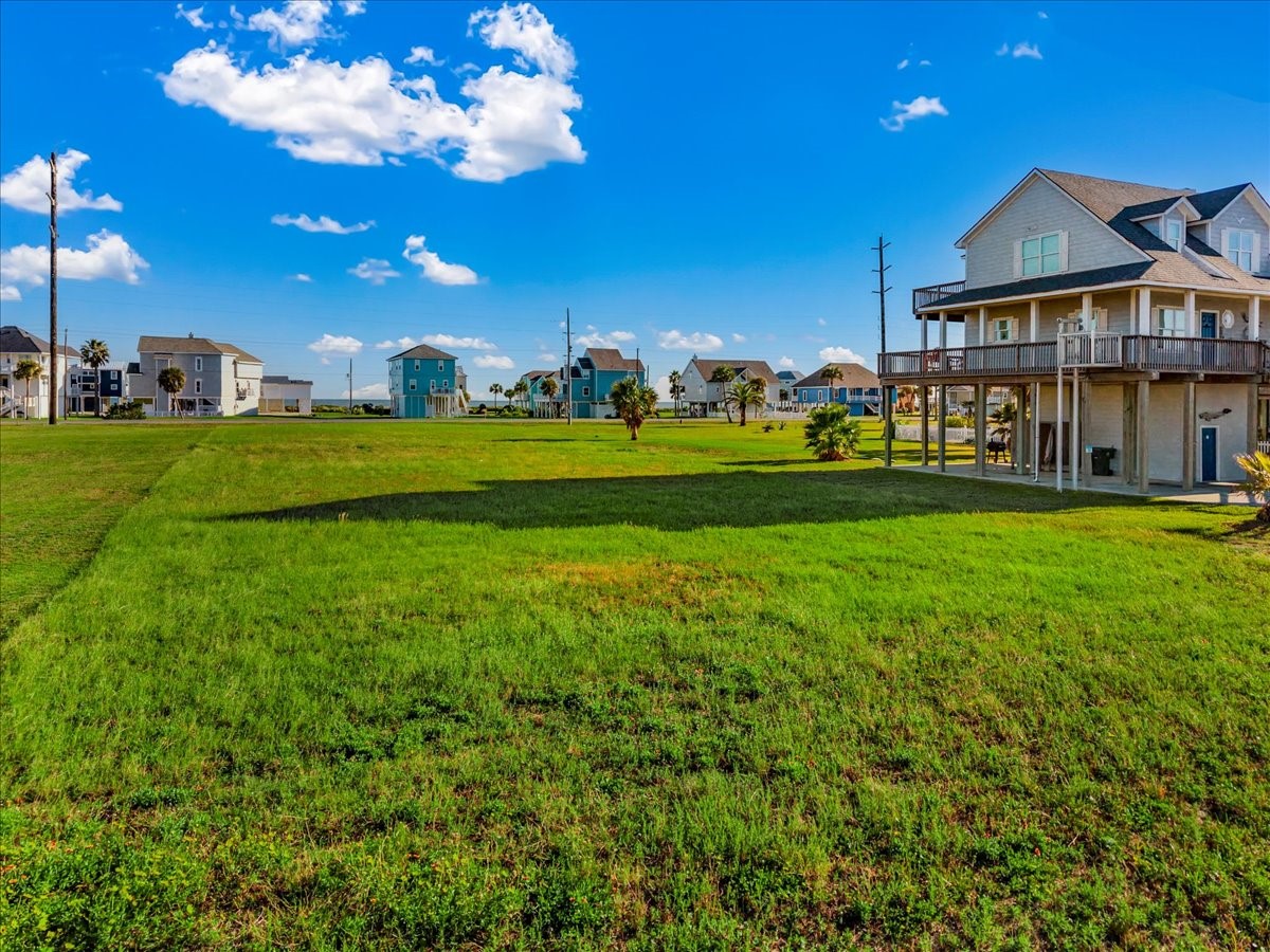 18703 Shaman Road Galveston, TX 77554 - Photo 13 of 20 a view of a big house with a big yard and potted plants