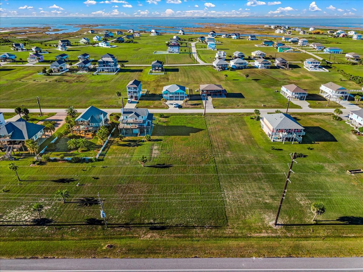 18703 Shaman Road Galveston, TX 77554 - Photo 18 of 20 a view of a lake with a yard