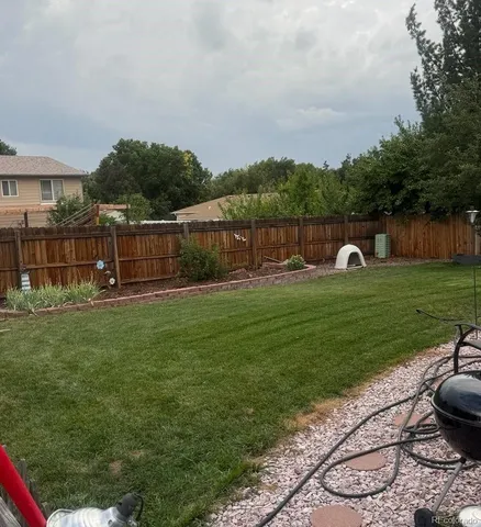 a backyard with swimming pool and green space