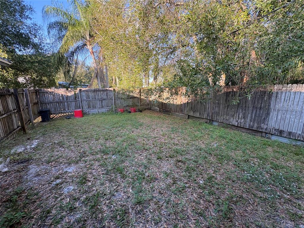 540 Northwest 24th Avenue Okeechobee, FL 34972 - Photo 12 of 24 a view of a yard with large trees and wooden fence