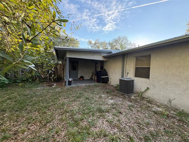 a view of a porch with furniture and a tree