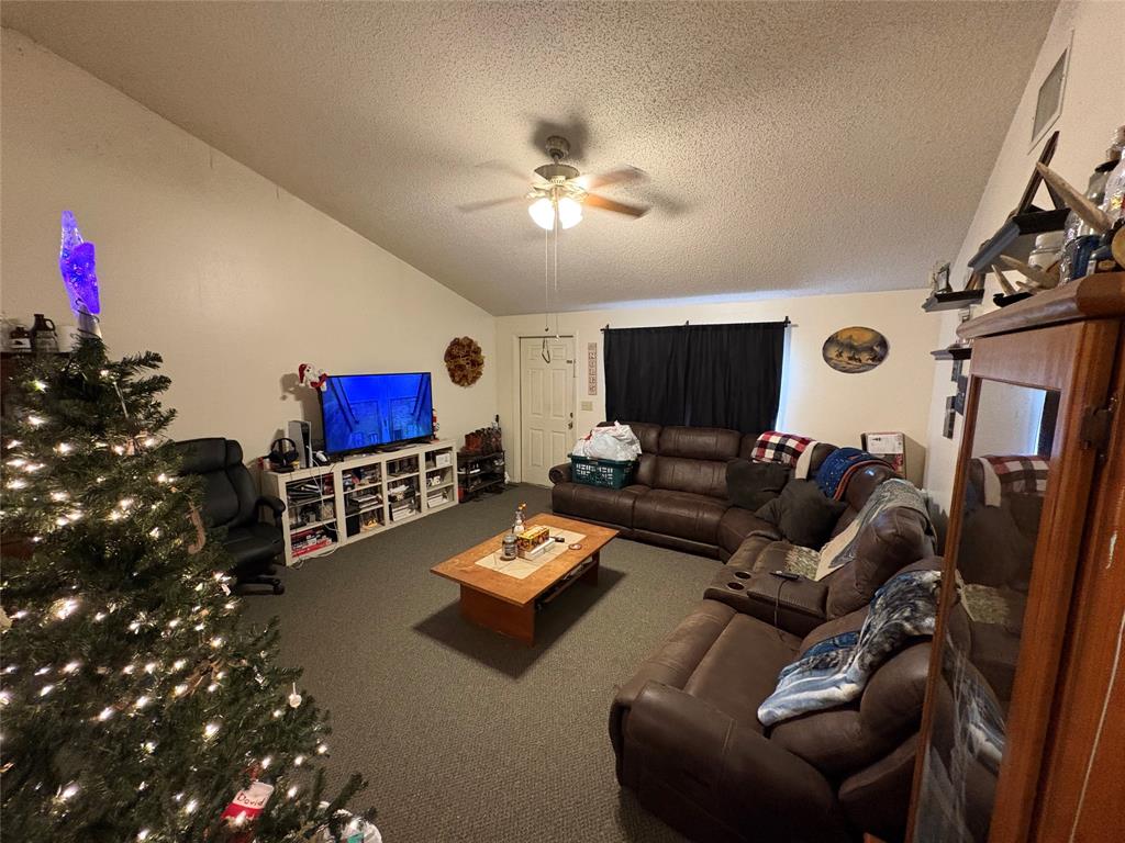 540 Northwest 24th Avenue Okeechobee, FL 34972 - Photo 5 of 24 a living room with furniture and a flat screen tv