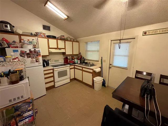 a kitchen with a sink appliances and cabinets