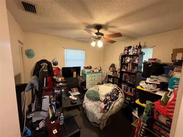 a bedroom with furniture and a chandelier