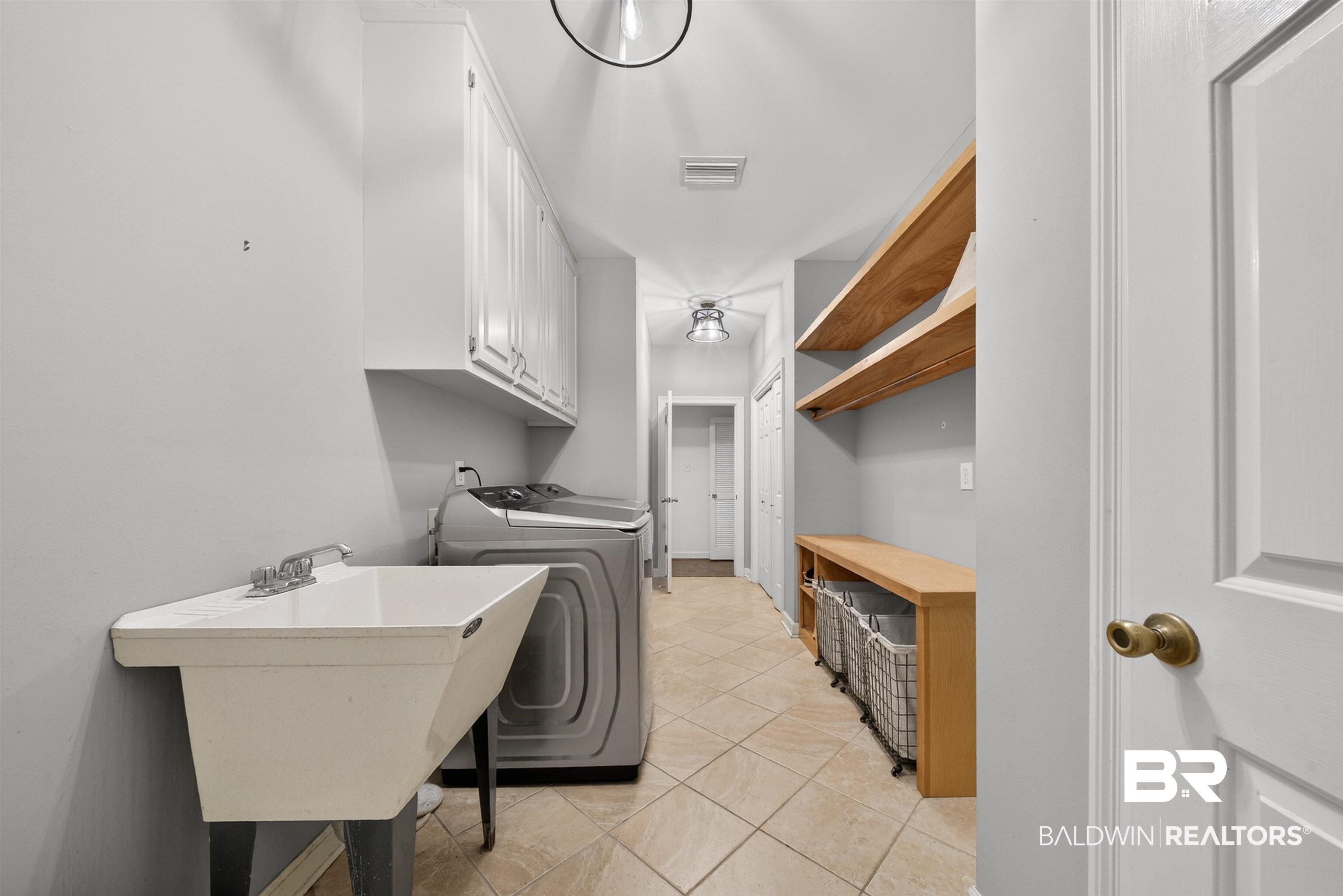 1250 Savannah Drive Mobile, AL 36609 - Photo 30 of 35 Laundry area with washer / dryer and light tile patterned floors