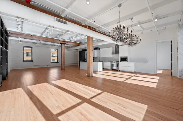 a view of a living room and chandelier